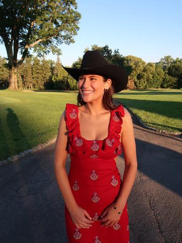 Rent with Reve customer in a red printed dress and hat