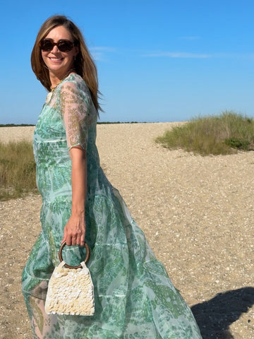 Rent with Reve customer in a green organza dress on the beach