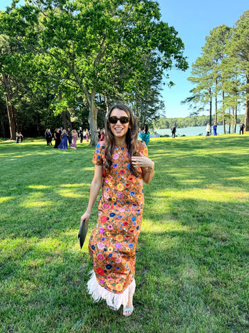 Rent with Reve customer in a floral dress at an outdoor event