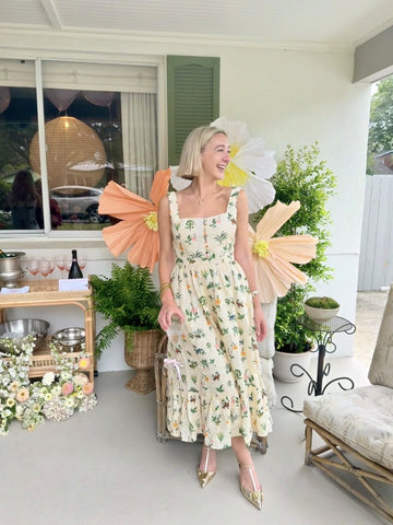 Rent with Rêve customer in a yellow botanical-print linen maxi dress